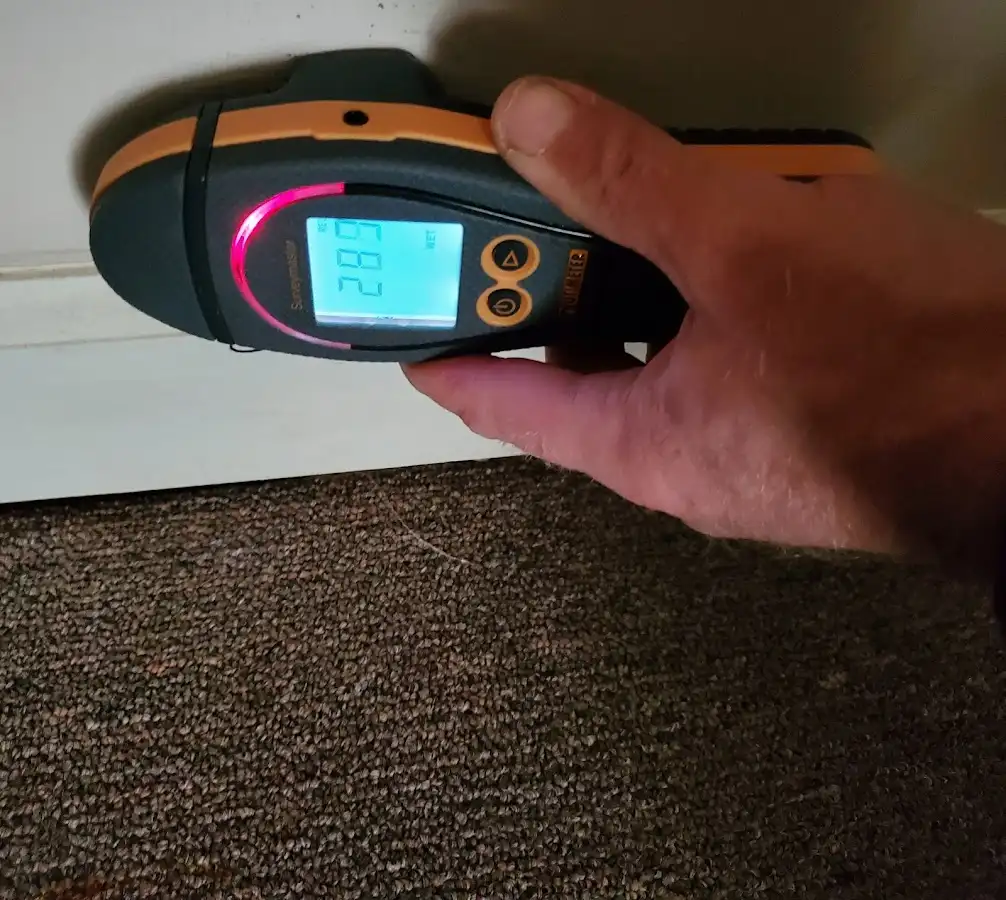 Moisture detection at baseboard during Storm Damage Restoration in Christiana